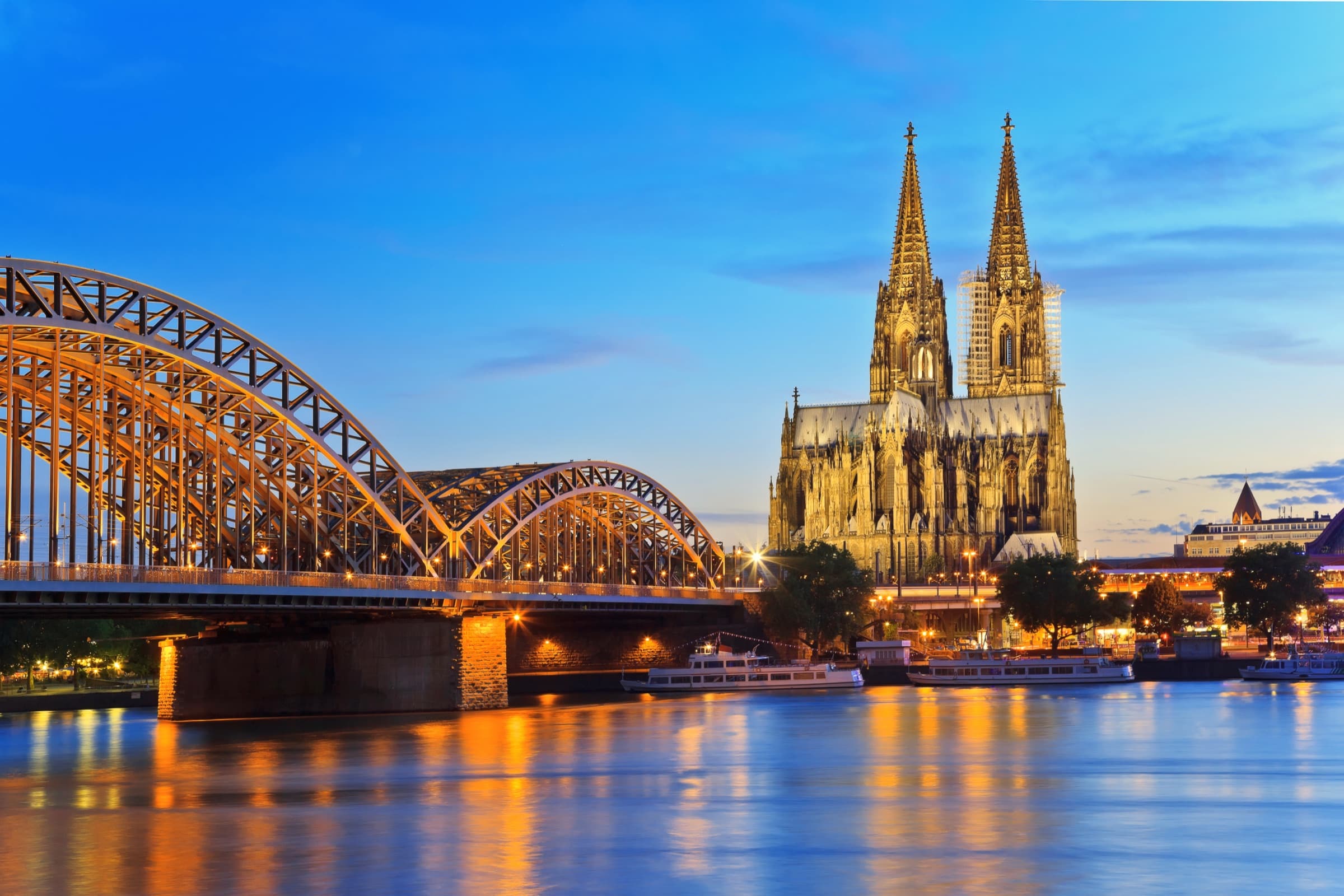 Cologne Cathedral and the Hohenzollern Bridge over the Rhine at dusk